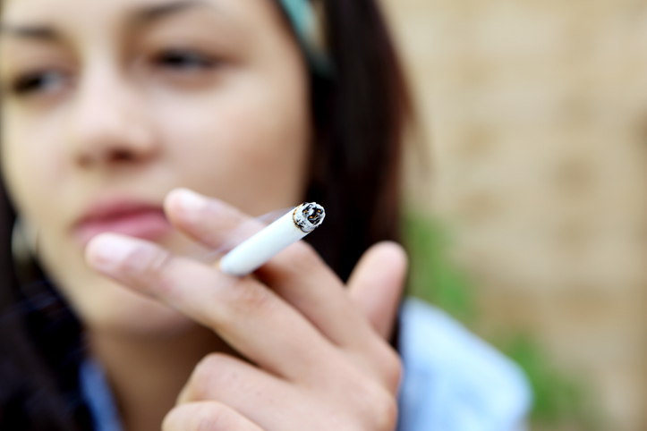 Pessoa segurando um cigarro na mão- Metrópoles