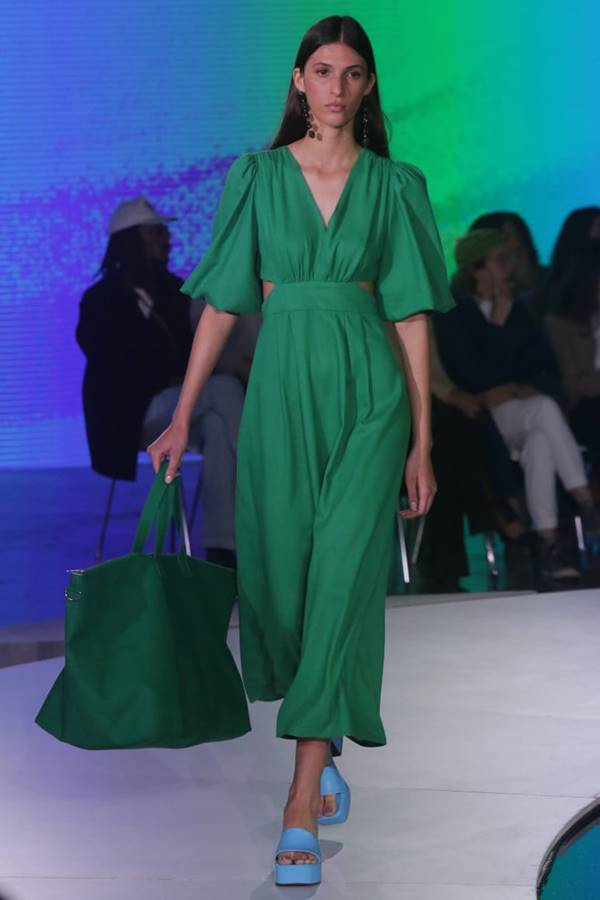 Na passarela da Renner, modelo usa vestido verde com maxi bag