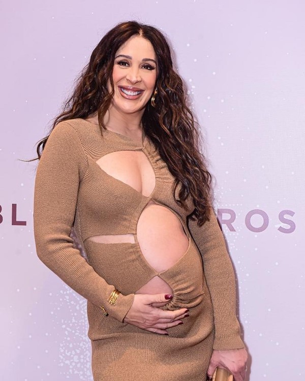 Na imagem com cor, Claudia Raia posa com a mão na barriga - Metrópoles 