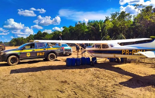 Imagem colorida de viatura da PRF e aeronave apreendida na Terra Indígena Yanomami