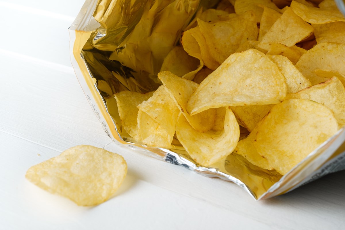 Foto colorida de batatas chips dentro de saquinho - Metrópoles