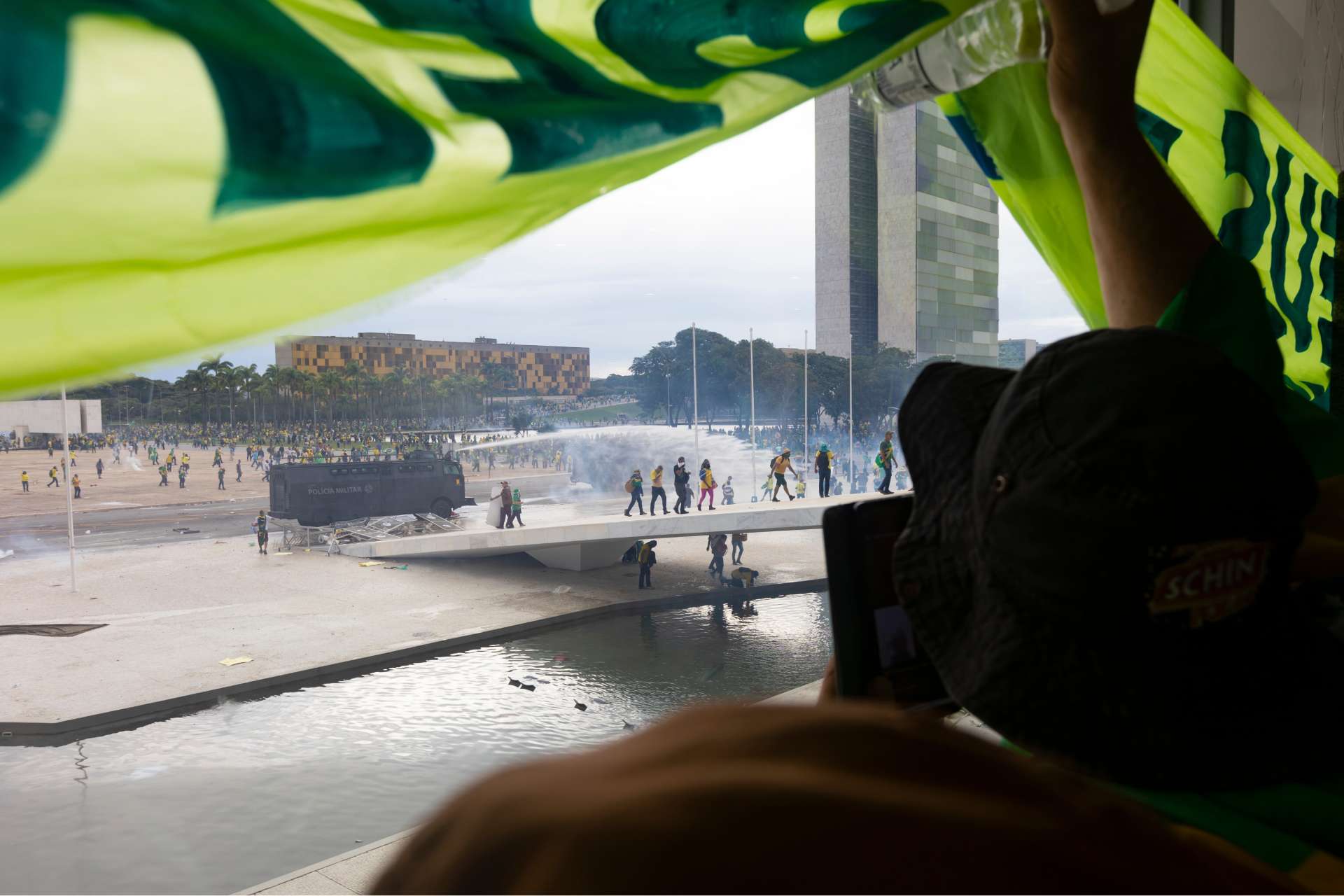 imagem de bolsonaristas invadindo o palácio do planalto e olhando para o congresso