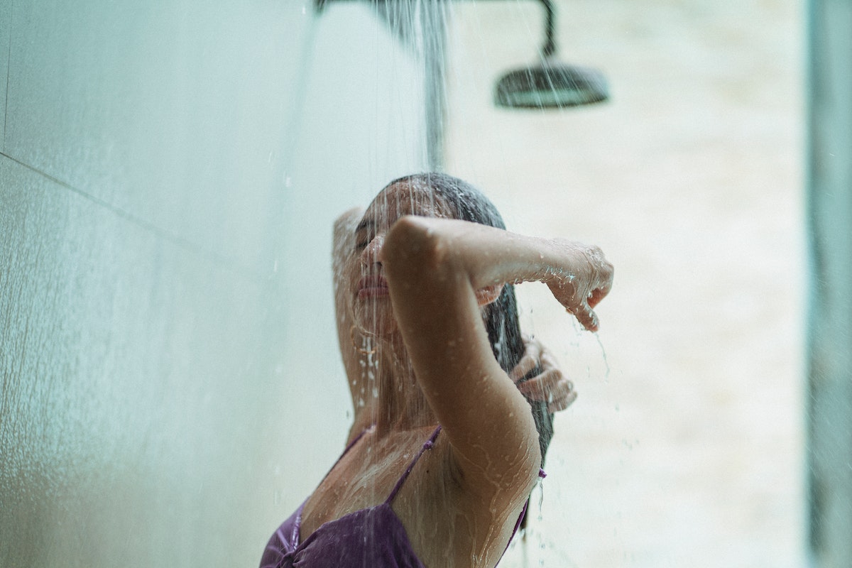 Mulher jovem lavando o cabelo - Metrópoles