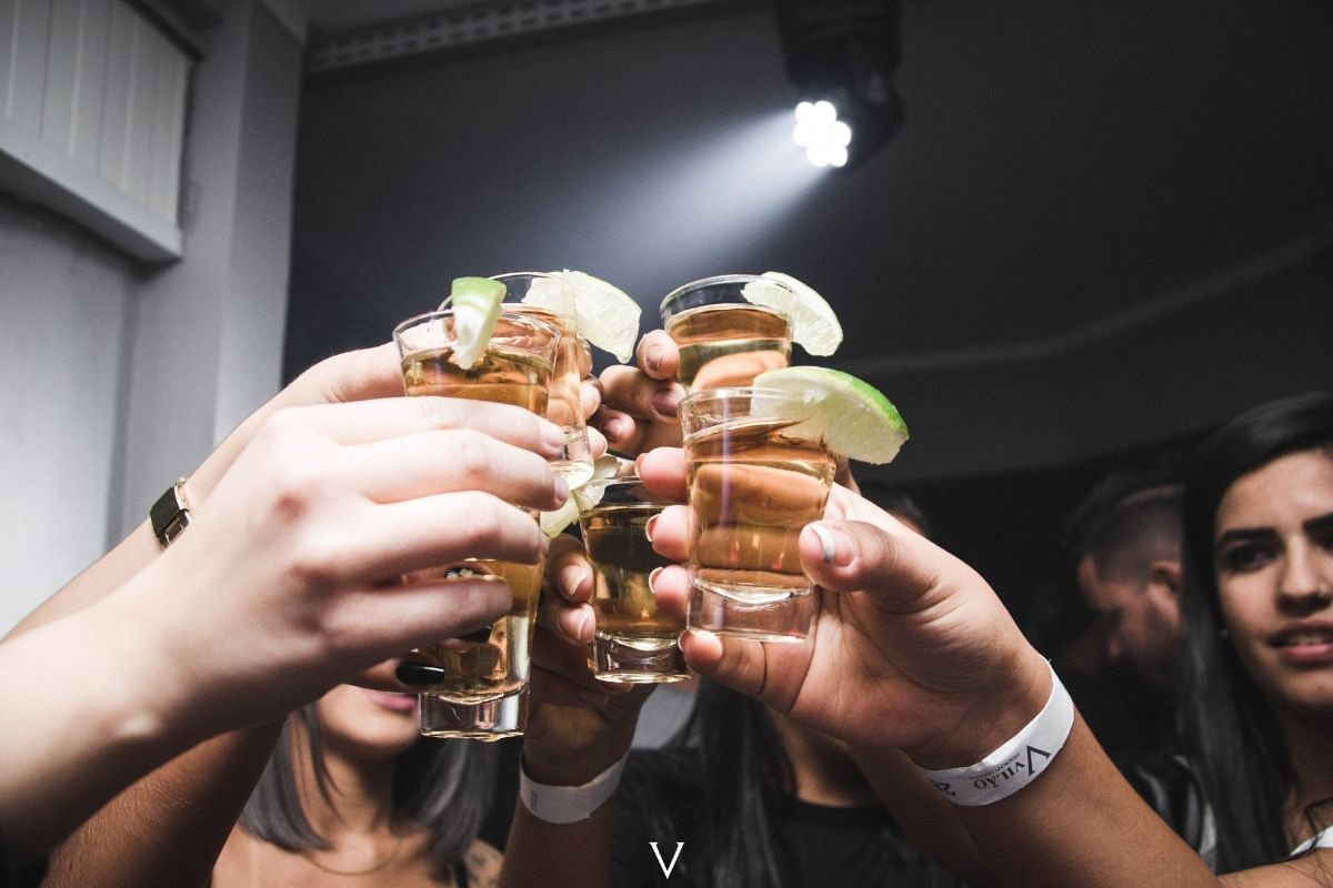 mãoes brindando com tequilas, bebida alcoólica