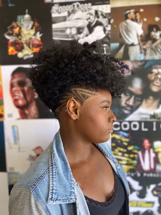 Na imgem com cor, mulher negra posa com o cabelo raspado na lateral - Metrópoles