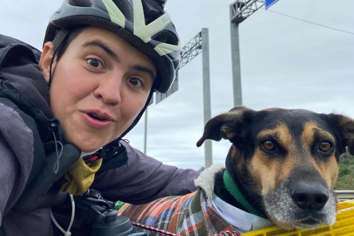 Foto colorida de uma mulher e seu cachorro - Metrópoles