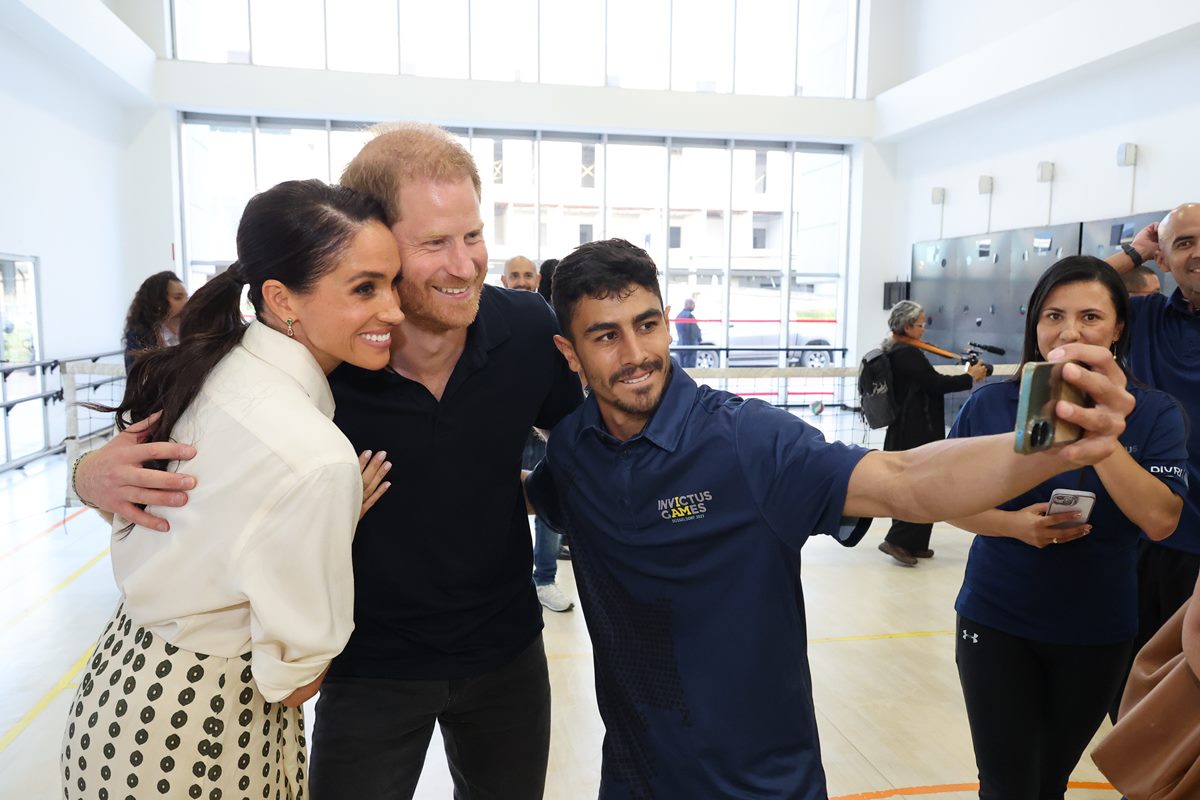 Foto colorida de mulher e dois homens fazendo selfie - Metrópoles