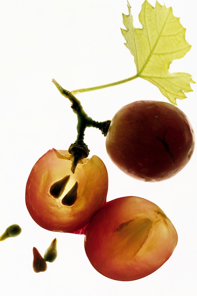 Foto colorida de cacho de uva e sementes da fruta - Metrópoles