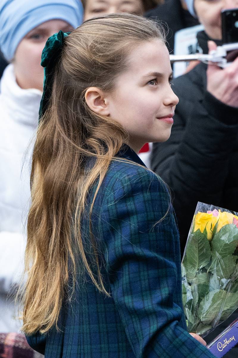 Foto colorida de menina com o cabelo loiro e preso com laço - Metrópoles