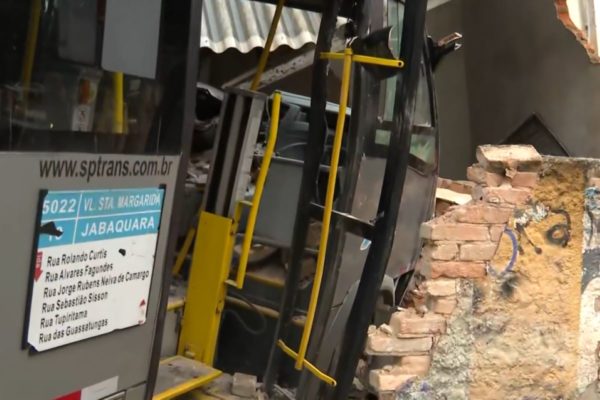 Imagem colorida mostra lateral de ônibus destruída ao bater em muro de concreto - Metrôpoles