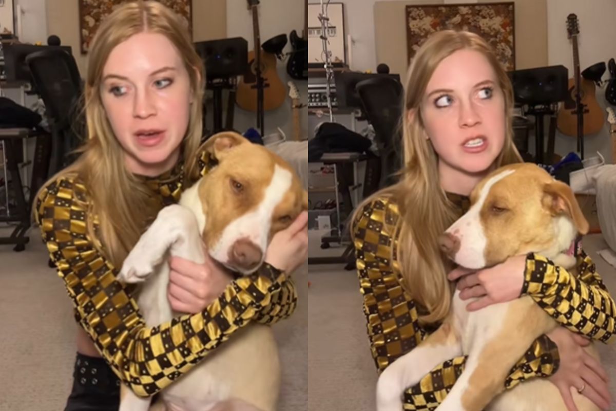 Imagem colorida de mulher com cadela no colo
