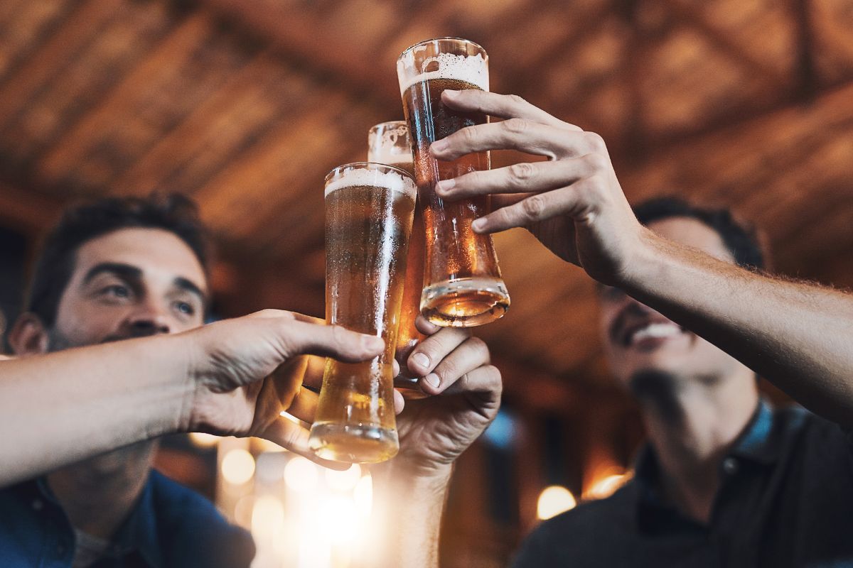 photo of men raising beer glasses