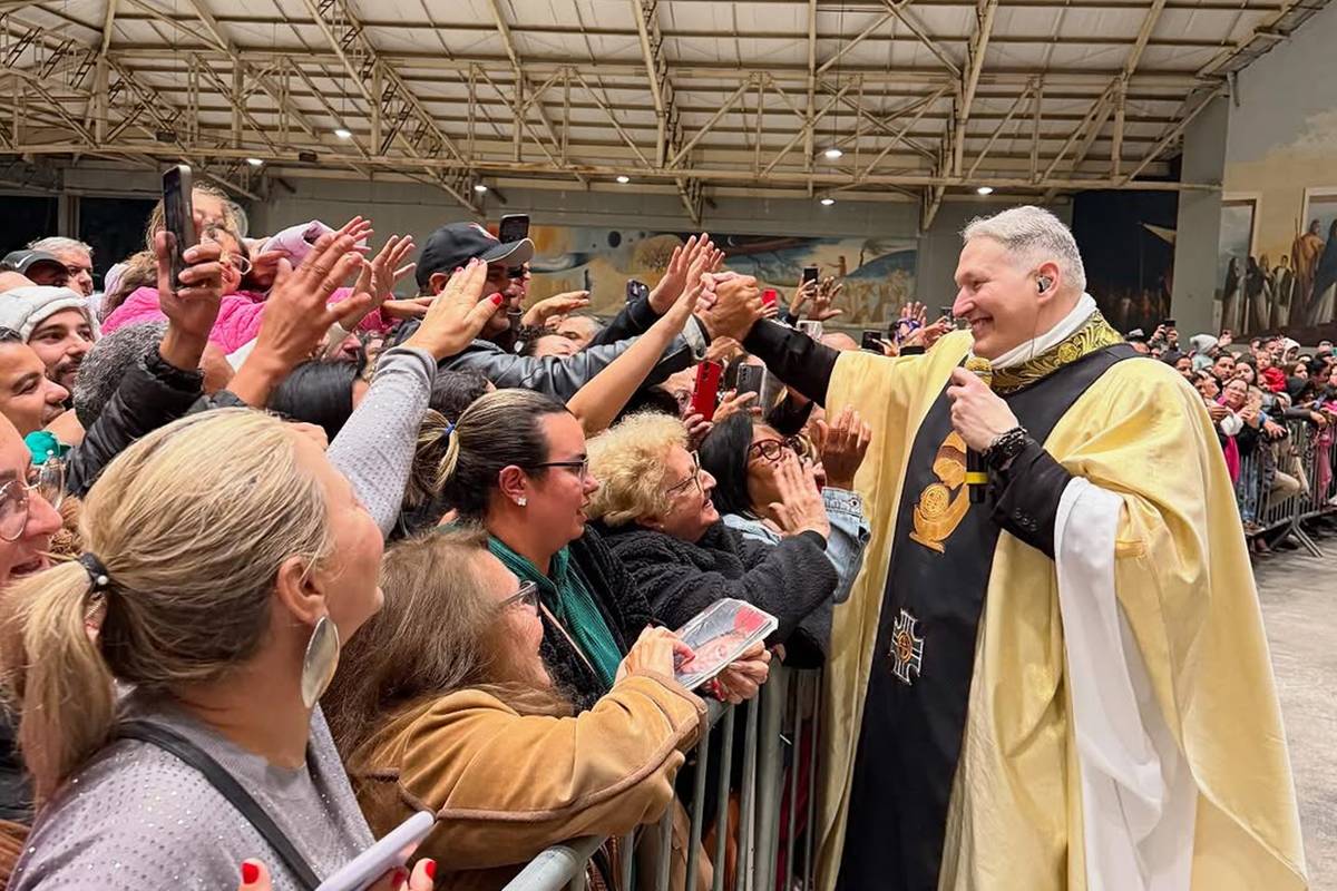 Foto de padre cumprimentando fiéis - Metrópoles