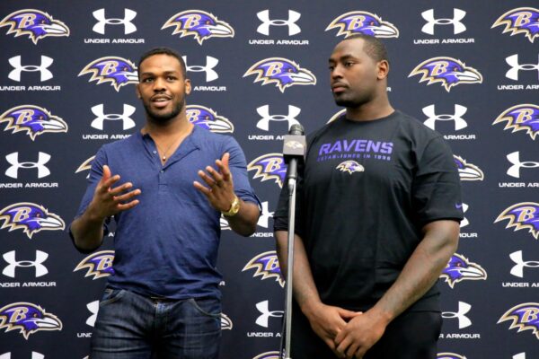 O lutador do UFC, Jon Jones (E), brinca com seu irmão, o defensive tackle, Arthur Jones , camisa 97 do Baltimore Ravens, durante uma coletiva de imprensa no centro de treinamento da equipe em 13 de novembro de 2013 em Owings Mills, Maryland.
